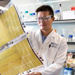 UQ person holding printed battery 